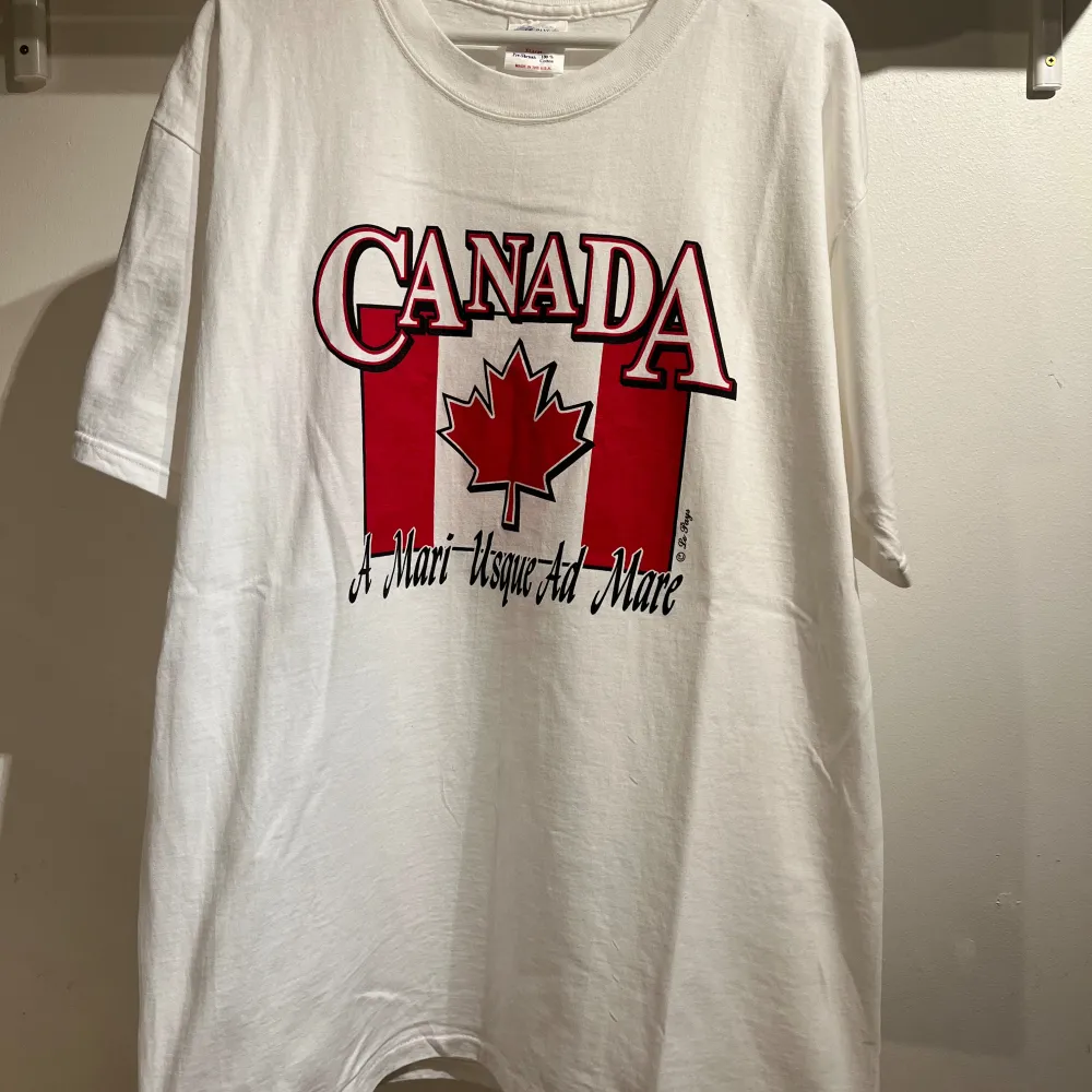 Vintage Vit 90s Canada T-shirt från Le Pays International. Made in USA. Storlek XL se mått: bredd 57 cm längd 80 cm Det finns en minimal fläck på uppe på höger axel se bild. Pris kan diskuteras!. T-shirts.