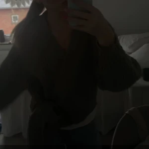 Omlåttkofta - Säljer en mysig grå/grön stickad omlottkofta med knytband i midjan. Koftan har långa ärmar och en ribbad struktur som ger en skön passform. Perfekt för kyliga dagar! Nästan aldrig andvänd och i toppen skick. Köpt för 350kr på Sellpy 💕