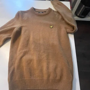 Beige tröja från Lyle & Scott - Säljer en stilren beige tröja från Lyle & scott. Perfekt för en avslappnad och snygg look. Storlek XS skulle säga att den passar 163-170 tröjan är 20% Kashmir med 80% ull som gör den skön och varm nypris tror jag låg på ungefär 1800kr för minsta lilla tveka inte att höra av er!😊