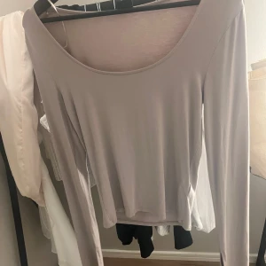 Beige långärmad topp från Gina  - Säljer en stilren beige långärmad topp från Zara. Toppen har en rund halsringning och är perfekt för lager-på-lager eller att bära som den är. Passar till många olika outfits och tillfällen.