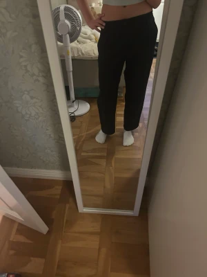 Svarta vida kostymbyxor - Säljer ett par svarta kostymbyxor med låg midja och raka, vida ben. Byxorna har diskreta fickor och stängs med knapp och dragkedja. 🎀