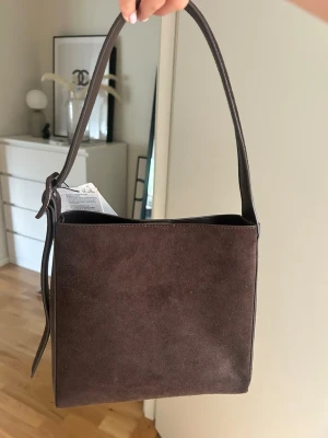 Brun axelväska i mocka - Jätte snygg brun mocka väska💗helt ny med prislappen kvar! 