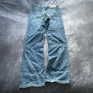 Ljusblå Joker Denim-vintagejeans för herr i storlek W32 L36 - Ljusblå vintagejeans från Joker Denim för herr i storlek W32 L36. W/L är uppskattningar baserade på måtten.  Mått 📏 Midja: 42 cm Benslut: 21 cm Lår: 33 cm Totallängd: 116 cm Måtten hittas även på bilderna  Leverans inom ett dygn Spara på priset och fraktkostnaderna genom att sätta ihop ett paket Mer info finns på min profil