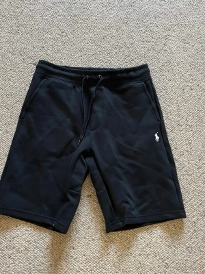 Polo Ralph lauren shorts  - Ett par svarta Polo Ralph lauren shorts med vit logga. De är i storlek M och i nytt skick. Pris kan diskuteras och skriv om du har några frågor. 