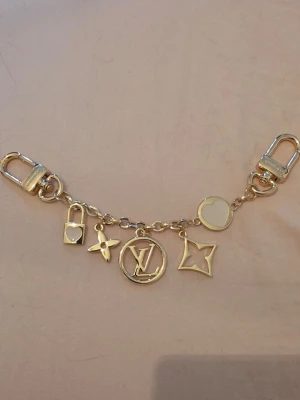 Louis Vuitton bag charm - LV bag charm. Oanvänd