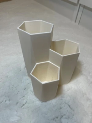 Hexagonformade vita pennställ - Säljer tre vita pennställ i plast med hexagonform. De har olika höjd och kan användas för att organisera pennor, penslar eller andra småsaker på skrivbordet. 