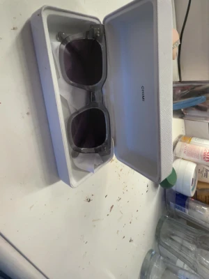 Grå transparenta solglasögon CHIMI - Snygga solglasögon från CHIMI med transparent grå båge och mörka glas. Modellen har en fyrkantig form och kommer i originalfodral. Perfekta för dig som vill ha en clean och modern look.