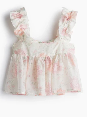 Blommig volangblus - Söt blommig blus i ljusa toner med volangdetaljer på axlarna och öppen rygg med knytband. Storlek M från H&M. Passar även S. Helt slutsåld. 