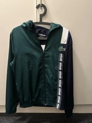 Lacoste vind jacka - Snygg lacoste jacka, användt sparsamt inga tydliga slitage. 