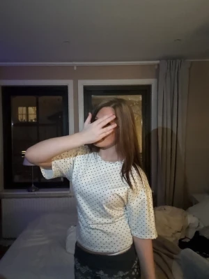 Vit t-shirt med svarta prickar - Säljer en super söt vkt tröja med svarta prickar på!                   Det är storlek L men den ska sitta ” tajt ” vid magen, själv har jag storlek xxs - S!! Och den sitter såhär!! Den är ny och använd två gånger, men den bara hänger i garderoben.