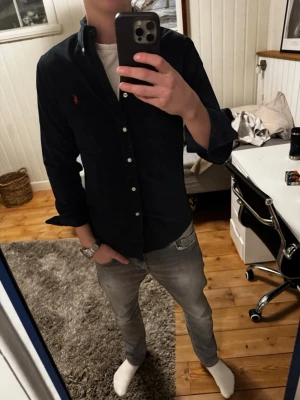 Ralph Lauren Skjorta - Snygg svart Ralph Lauren skjorta | Kanon skick | Modellen på bilden är 182 och väger 70 kg | Materialet är maschester tyg 