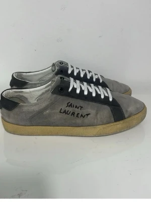 Saint Laurent Skor - Säljer nu dessa super snygga gråa Saint Laurent skor som har lite slitningar i populär design. Storlek 45,5 men passar 45, skriv för fler bilder/frågor🙌🏼