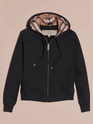 Svart hoodie med Burberry-mönstrad huva - Säljer en svart zip-hoodie från Burberry med klassiskt rutigt mönster i huvan. Hoodien har dragsko, två fickor framtill och ribbade muddar. Perfekt för dig som vill ha en stilren hoodie med en lyxig twist.