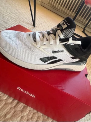 Vita och svarta Reebok Nano X1 - Snygga Reebok Nano X1 träningsskor i vitt och svart med stickad ovandel och robust sula. Perfekta till funktionell träning och gym. Endast prövade. 