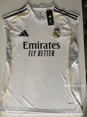 Real Madrid matchtröja Adidas vit - Stilren och högkvalitativ fotbollströja inspirerad av Real Madrids senaste design. Tillverkad i ett lätt och ventilerande material som ger hög komfort både vid träning och i vardagen. Storlekar: S, M, L Skick: Ny