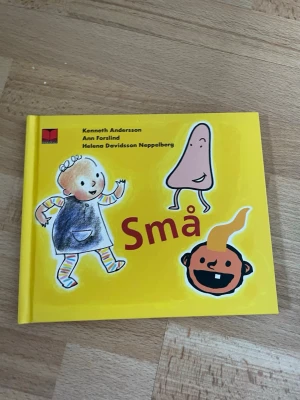 Små - barnbok med färgglada bilder - En färgglad barnbok med titeln 'Små' av Kenneth Andersson, Ann Forslind och Helena Davidsson Neppelberg. Boken har hårda pärmar i gul färg och illustrationer av barn, näsa och ansikte på omslaget. Perfekt för yngre läsare som gillar enkla och lekfulla bilder.
