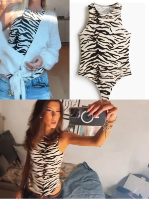 Zebramönstrad body från H&M - Säljer en zebramönstrad body från H&M i svart och vitt. Bodyn har ärmlös design, rund halsringning och åtsittande passform. Perfekt att styla med jeans eller kjol för en trendig look. Materialet är stretchigt och mjukt för extra komfort.