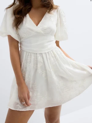 Vit kort studentklänning - Helt ny studentklänning från Gina Tricot, med lappen kvar! Nypris: 699kr! 🎉Superfin vit kort omlottklänning med broderade blommor, puffärmar och v-ringning. Klänningen har en markerad midja, volangig kjol och en stor rosett bak. Perfekt för sommarens alla tillfällen! Skickar antingen samma dag som köpet görs eller dagen efter, beroende på tiden man gör köpet såklart 🥰