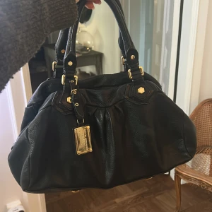 Marc Jacobs Classic Q väska - Säljer en svart Marc Jacobs handväska i en modell som inte säljs längre, därav priset! Den är i jättebra skicka och perfekt till skolan, man kan få plats med en dator i den om man pressar. Jättesnygg till alla outfits! Pris kan diskuteras. 