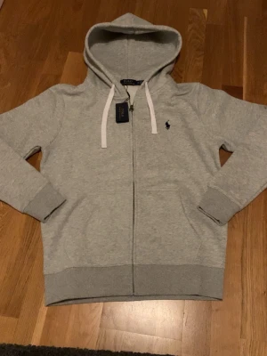 Grey hoodie - Very nice gray zip up hoodie. Suits absolutely anyone and can definitely improve your closet. Fit is very snugg and comfortable. Very new and excellent condition. 