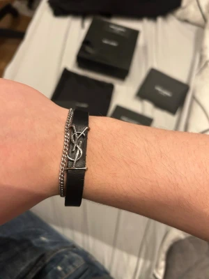 Saint Laurent armband  - Extremt fett ysl armband som jag nu säljer!💸🍾 Skicket är bra utom lite missfärgning på baksidan (se bild) något som ej synd när de används! Allt og finns förutom kvittot! Allt og medföljer! 👀