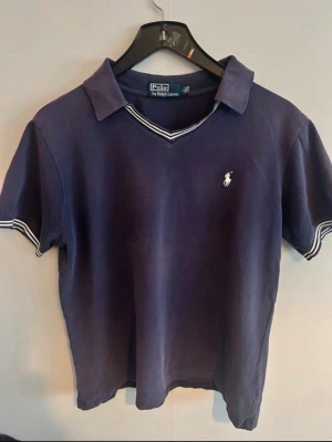 Polo Ralph Lauren piké - • 🇸🇪 Marin blå Piké från Polo Ralph Lauren. Broderad logga på bröstet.   Använd, men fortfarande i fräscht skick utan några speciella anmärkningar.   Pris går alltid att diskutera vid snabb affär 🥂   Storleken är L men sitter som M**