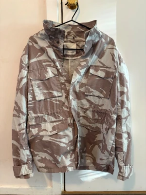 Kamouflage field jacket Samsoe Samsoe  - Säljer nu denna sjukt feta och eftertraktade jacka från samsoe samsoe. Väldigt unik och passar perfekt om du vill ha en lite avslappnad stil. Mycket bra skick förutom en liten fläck på etiketten som såklart inte kommer synas. Storlek S men passar mer som M. Tveka inte på att höra av er om ni har funderingar! // Victor 😁🤝