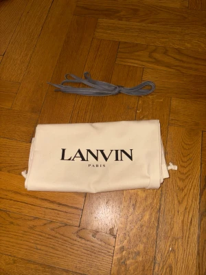 Gråa mockasneakers från Lanvin - Säljer ett par grå Lanvin-sneakers. Stilrena och i gott skick. Skorna är i storlek 42 men passar även dig som brukar ha 43. Extra snören samt original dustbag ingår.