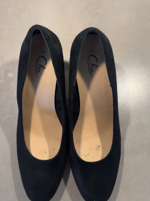 Svarta pumps från Clou -  svarta pumps från Clou med rundad tå och bred klack. Skorna är i mocka!