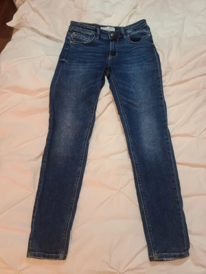Mörkblå skinny jeans från Stradivarius - Säljer ett par mörkblå skinny jeans från Stradivarius med klassisk femficksmodell och låg midja. Stretchiga. Jag skulle säga att de känns små i storleken, men stretchen kanske gör sitt?
