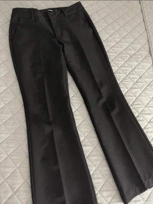 Svarta kostymbyxor från bikbok  - Snygga svarta kostymbyxor från BIKBOK med låg midja. Modellen heter Vera. Är i storlek 34 PETITE. Jätte snygga och mycket bra skick.