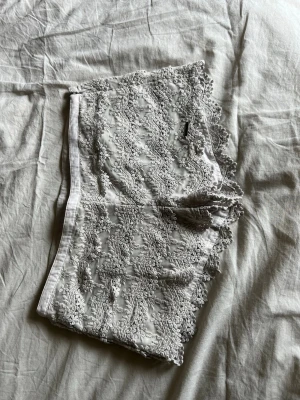 Vita spets shorts - Säljer ett par vita shorts med vacker spets och blommigt mönster. Shortsen har en diskret dragkedja i sidan och är fodrade för extra komfort. Perfekta för en sommaren. Skriv om frågor💕