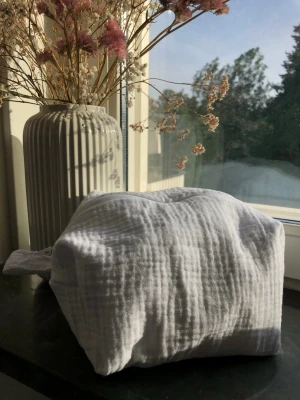 Self made muslin necessär - Jag säljer denna fina necessären jag gjort själv för ett rabatterat pris pågrund av formen och fel. Den är inte symmetrisk och perfekt gjord så därför lågt pris. bredd:14,5 cm höjd:12 cm längd:18 cm