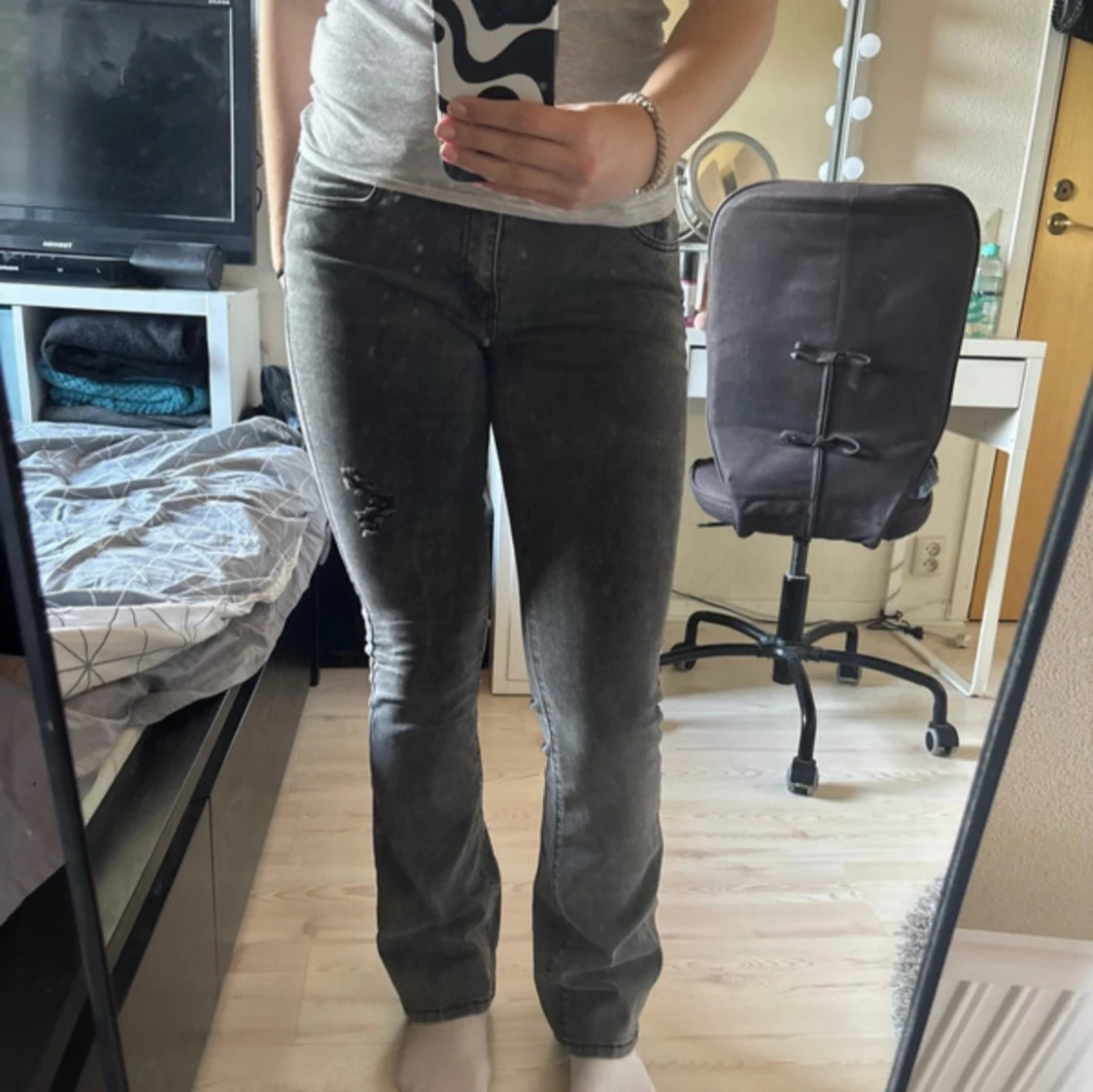 Grå jeansbyxor med slitning