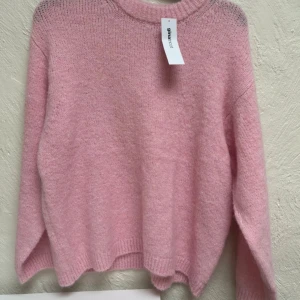 Rosa stickad tröja från Gina Tricot💖 - Supermjuk och boxy stickad tröja i ljusrosa från Gina Tricot. Tröjan har en avslappnad passform, ribbad rund halsringning och långa ärmar. Perfekt att slänga på sig när du vill vara både comfy och snygg.