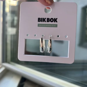Silvriga chunky örhängen från Bik Bok - Snygga chunky örhängen i silverfärg från Bik Bok. De har en modern, rundad form och är tillverkade av återvunnet material. Perfekta för att ge din look lite extra edge och passar till alla stilar. Enkla att matcha med andra smycken och accessoarer.