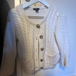 Vit stickad kofta från H&M - Säljer en gullig kofta som passar in både på vintern o sommaren, jag väljer att sälja då den inte kommer till användning. Koftan är trekvarts ärmad! 💛Om ni skulle vara intresserade hör gärna av er om ni undrar något!💛