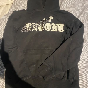 Svart hoodie från Demont Shop - Svart hoodie från Demont Shop med stort vitt tryck på bröstet och en stjärndetalj. Klassisk huva och magficka framtill. Perfekt för dig som gillar streetwear och vill ha en snygg och bekväm tröja.tröjan tvättas såklart innan jag skickar den.pris kan diskuteras 
