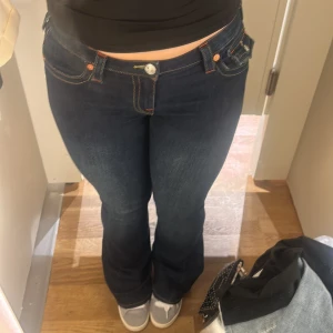 Mörkblå True religion Joey Low Rise Flare jeans - Säljer ett par mörkblå jeans True Religion ❤️ i modellen Joey, strl 29 (passar typ L) väldigt stretchiga 🫶🏻 superfina men tyvärr blivit för stora för mig. Pris kan diskuteras och skriv om ni undrar ngt 🌟