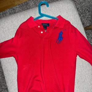 Röd pikétröja från Polo Ralph Lauren - Säljer en klassisk röd pikétröja från Polo Ralph Lauren. Mycket sparsamt använd och äkta.