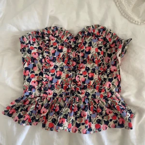 Blommig korsett med volang - Supersöt korsett med blommigt mönster! Säljer då den inte har används🥰🙌🙌