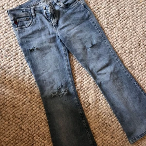 Lågmidjade utsvängda jeans med hål - Bra skick!