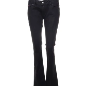 Lågmidjade bootcut jeans från Hilfiger Denim  - Populära svarta jeans från Hilfiger Denim med bootcut passform, lågmidjade och klassisk femficksdesign. Jeansen har en snygg utsvängd siluett nertill och är tillverkade i ett stretchigt denimtyg som sitter skönt. Perfekta för dig som gillar en tidlös look med lite edge.