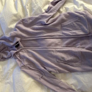 Kashmir luvtröja  - Kashmir huvtröja med dragkedja framtill, två stora fickor och justerbar huva. Perfekt för chill dagar eller när du vill ha en avslappnad stil. Långärmad och i mjukt bomullsmaterial.