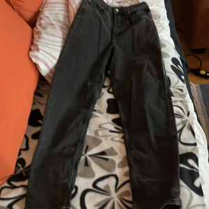 Svarta jeansbyxor - Snygga svarta jeansbyxor med en klassisk design. Perfekta för en stilren look. De har en normal passform och är tillverkade i ett slitstarkt material.