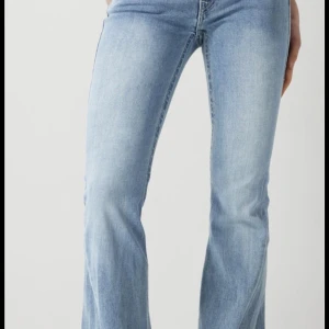Blå bootcut jeans - Snygga ljusblåa lågmidjade jeans från true religion i modell joey. Dem är i typ nyskick, väldigt få gånger andvända. 