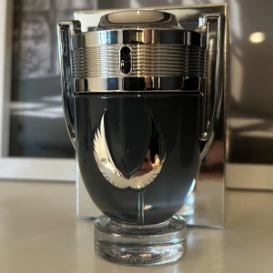 Invictus Platinum - Snygg parfymflaska i form av en trofé med silverdetaljer och en mörk bas. Flaskan har en elegant design med en vingliknande symbol på framsidan. Perfekt vår/sommarparfym. 47/50ml
