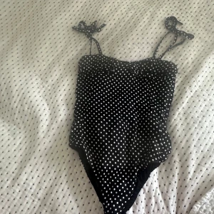 Svart prickig body från Zara - Söt body med justerbara knytband från Zara. Mycket fint skick utan defekter. Storleken är S men är åt det mindre hållet så passar också XS. 💗
