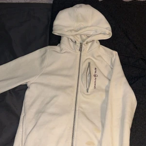 Sail Racing hoodie med dragkedja - Säljer tre snygga hoodies från Sail Racing i färgerna vit, grå och svart. Alla har hel dragkedja, huva och en bröstficka med logga. Perfekt för dig som gillar sportig och clean stil. Materialet är mjukt och känns skönt mot huden. Långärmad modell med normal passform. Storlekarna på svarta och vita är 160 cm och på gråa är det 170 cm. 