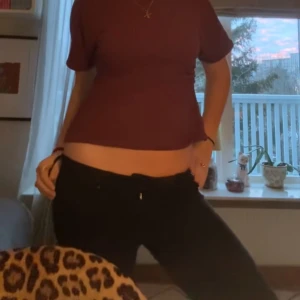 Svarta Lågmidjade jeans från Vero Moda - Svarta bootcut Lågmidjade jeans från vero Moda. Midjemått: 39cm-42cm vid stretch, innerbenslängd-75cm. Väl använda och har ett litet hål vid skrevet, därav priset.